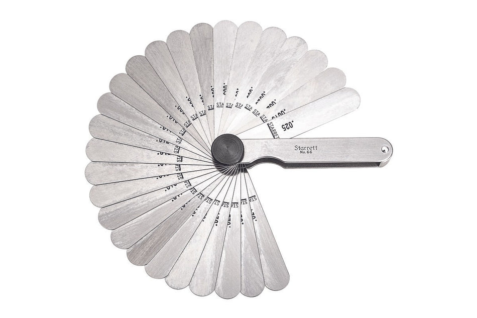 Metal feeler gage on a white background